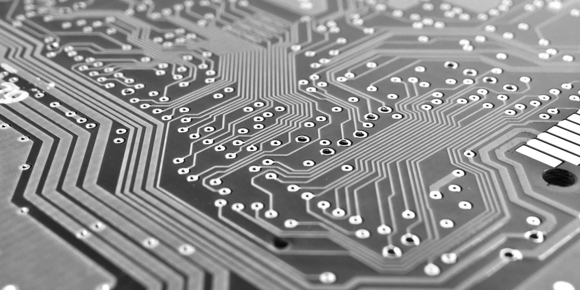 A grayscale close-up of a circuitboard