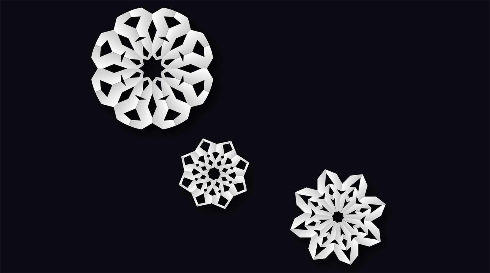 Screenshot of three CSS paper snowflakes on black background